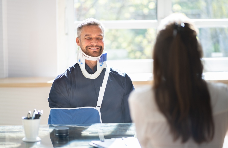 injured man consults with lawyer after car accident
