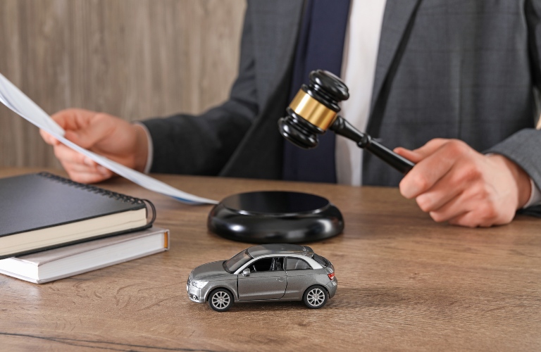 Man with document and gavel at wooden table